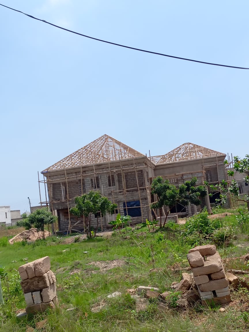ADM Roofing Ventures team installing wooden roof trusses
