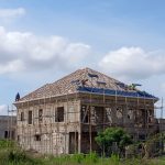 ADM Roofing Ventures team installing wooden roof trusses